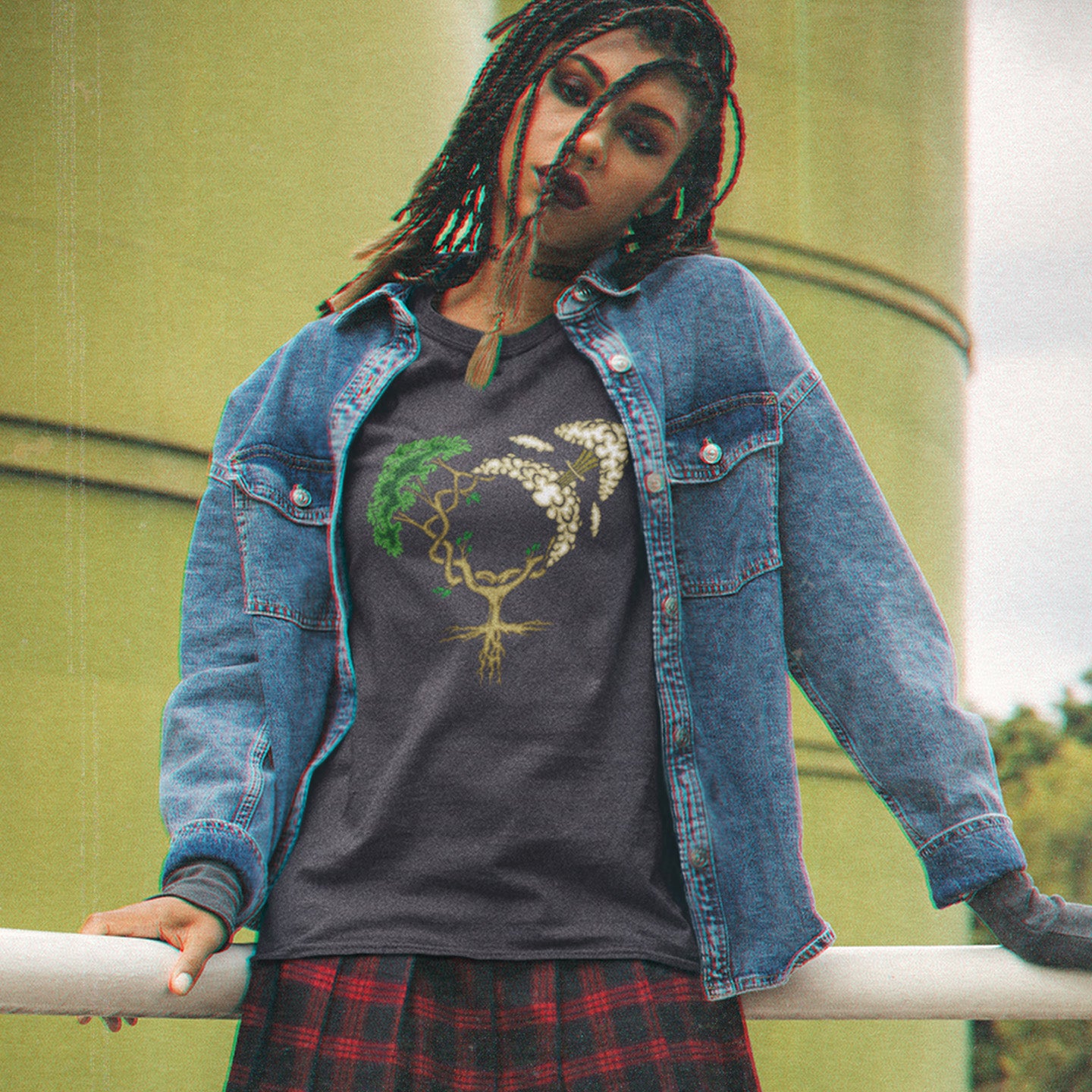 Person wearing a denim jacket over a graphic t-shirt with a plaid skirt, standing outdoors. A women's rights t-shirt design that pays homage to women and promotes social awareness of how most destructive elements of humankind come from men. Women create life, men destroy it. Made from 100% organic ring-spun cotton, this women power t-shirt is unisex, high-quality, super comfy, and best of all, eco-friendly.