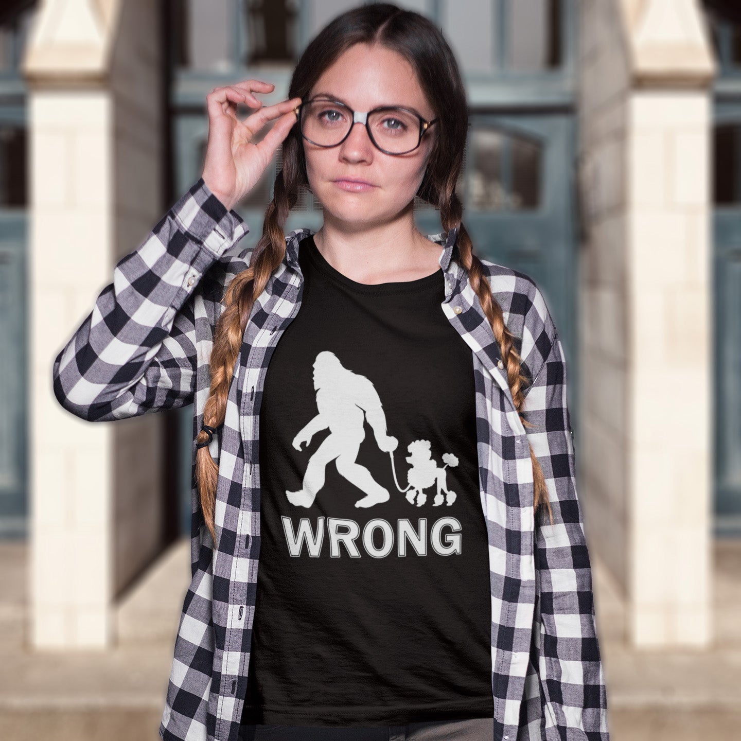 Person wearing a black t-shirt with a graphic design and text, standing outdoors. A funny Bigfoot t-shirt questioning the limits of acceptability. A poodle will never be the dog of choice for the Bigfoot. However open minded you are there are some things that will never look right. Made from 100% organic ring-spun cotton, this bigfoot t-shirt is unisex, high-quality, super comfy, and best of all, eco-friendly.