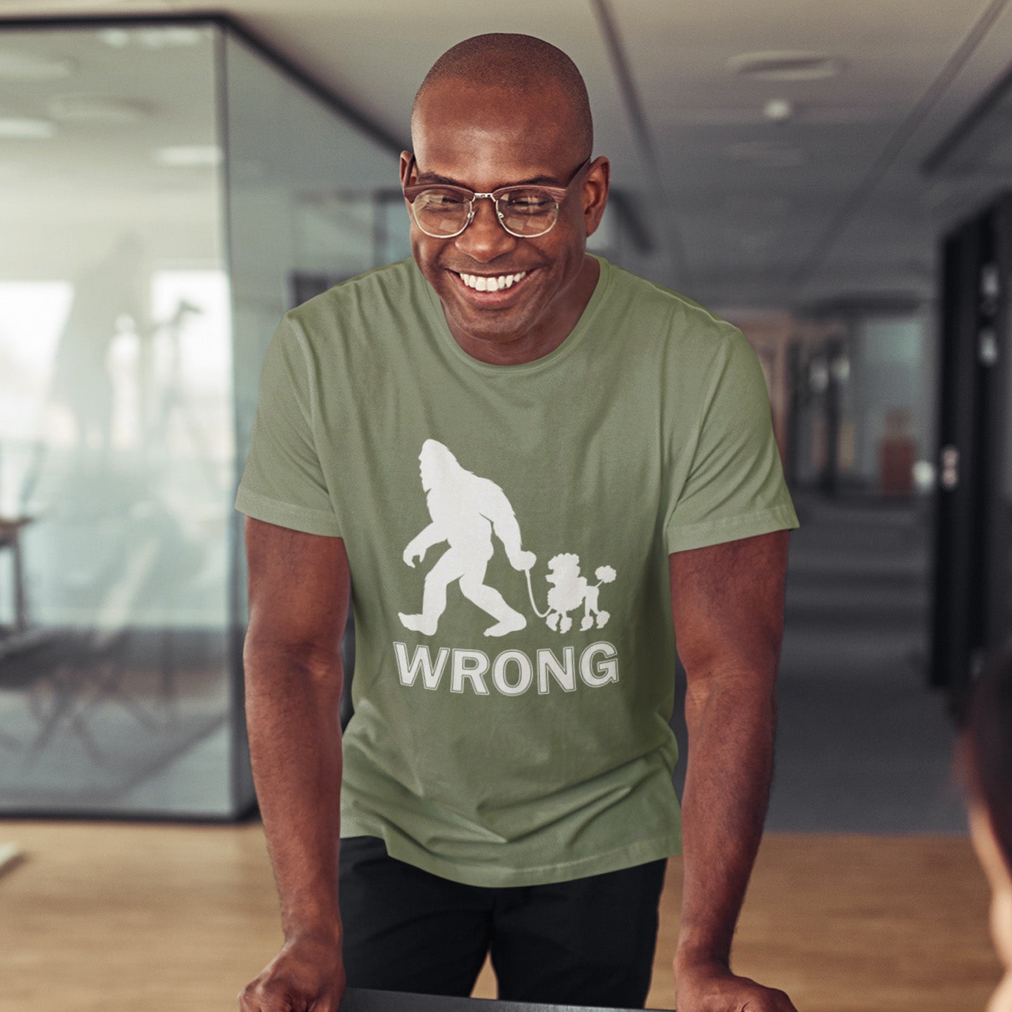 Man wearing a khaki t-shirt with a graphic design in an indoor setting. A funny Bigfoot t-shirt questioning the limits of acceptability. A poodle will never be the dog of choice for the Bigfoot. However open minded you are there are some things that will never look right. Made from 100% organic ring-spun cotton, this bigfoot t-shirt is unisex, high-quality, super comfy, and best of all, eco-friendly.