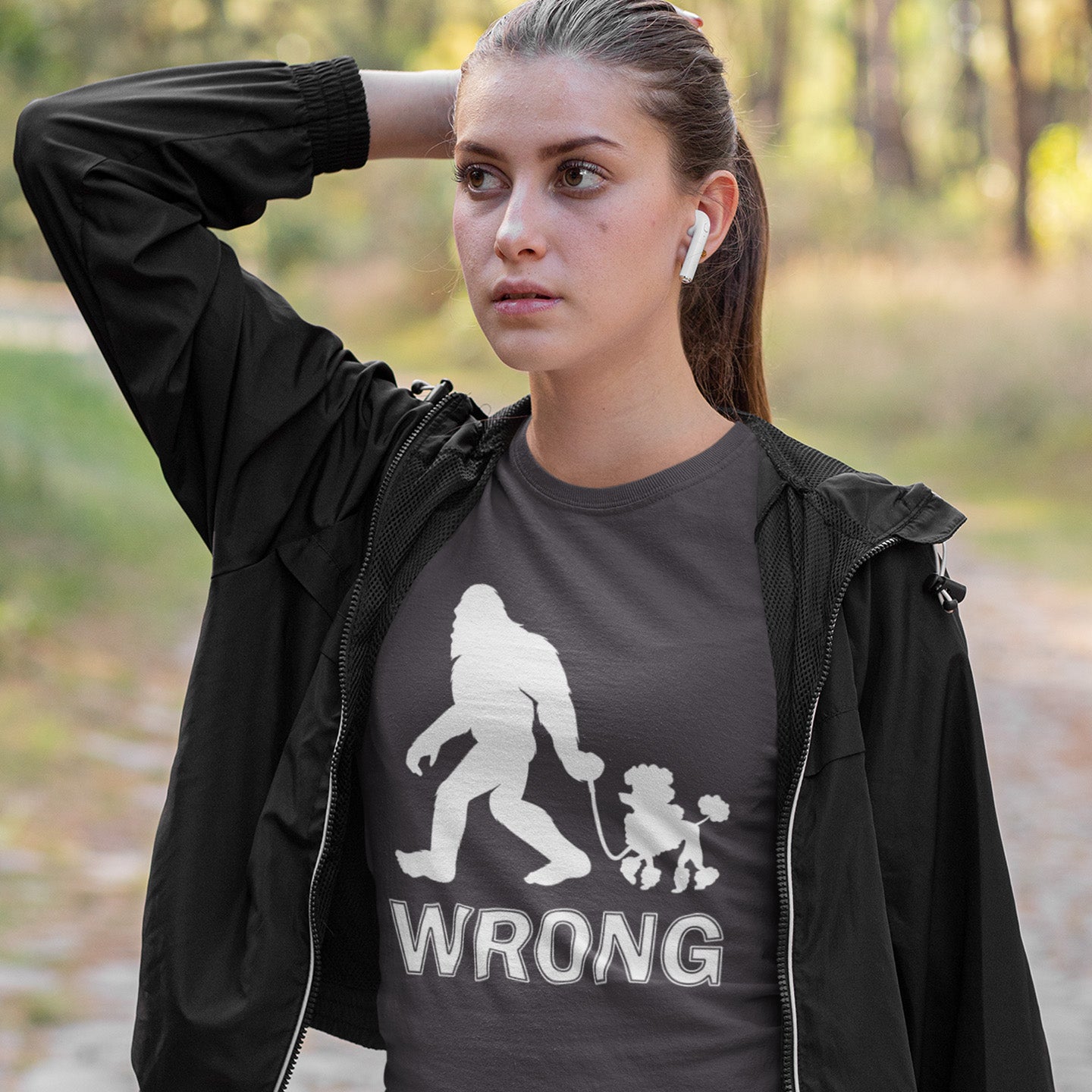 Woman wearing a anthracite t-shirt with a graphic design and text, standing outdoors. A funny Bigfoot t-shirt questioning the limits of acceptability. A poodle will never be the dog of choice for the Bigfoot. However open minded you are there are some things that will never look right. Made from 100% organic ring-spun cotton, this funny bigfoot t shirt is unisex, high-quality, super comfy, and best of all, eco-friendly.