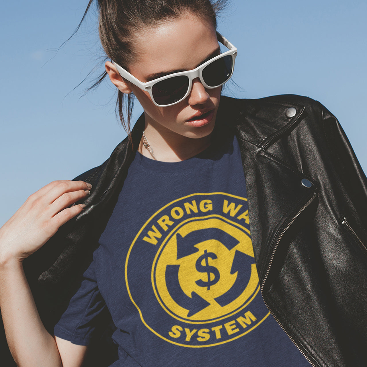 Person wearing a blue t-shirt with a yellow graphic design against a clear blue sky. A political t-shirt in the form of a road sign reminder that it's possibly not been the best idea to build our society around money. Wrong direction, change the system ! Made from 100% organic ring-spun cotton, this social awareness political t-shirt is unisex, high-quality, super comfy, and best of all, eco-friendly. A great choice for an anti-capitalist socio-economic demonstration.