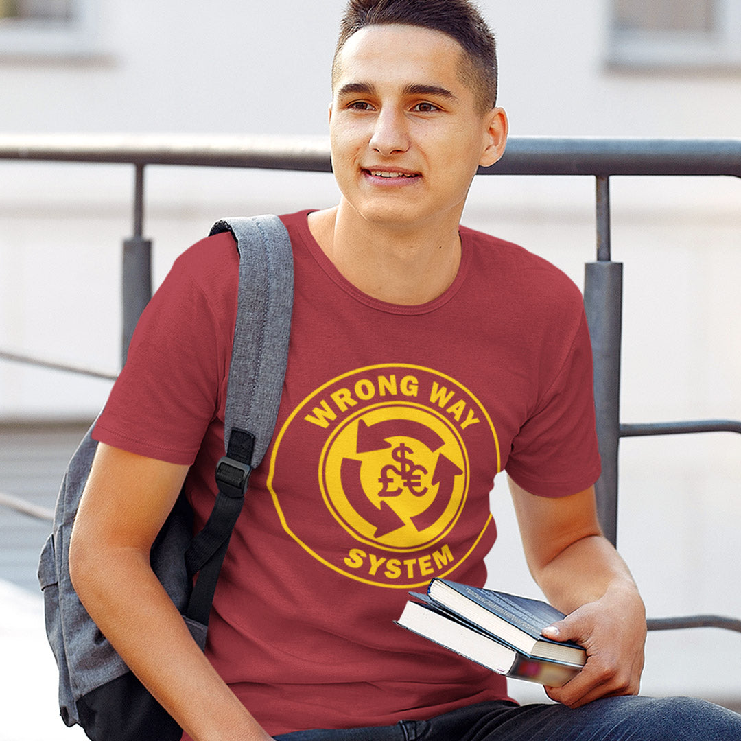 Person wearing a red t-shirt with a yellow graphic design, holding books, and sitting outdoors. A non conformist t shirt in the form of a road sign reminder that it's possibly not been the best idea to build our society around money. Wrong direction, change the system ! Made from 100% organic ring-spun cotton, this social awareness t shirt is unisex, high-quality, super comfy, and best of all, eco-friendly. A great choice for an anti capitalist socio economic demonstration.
