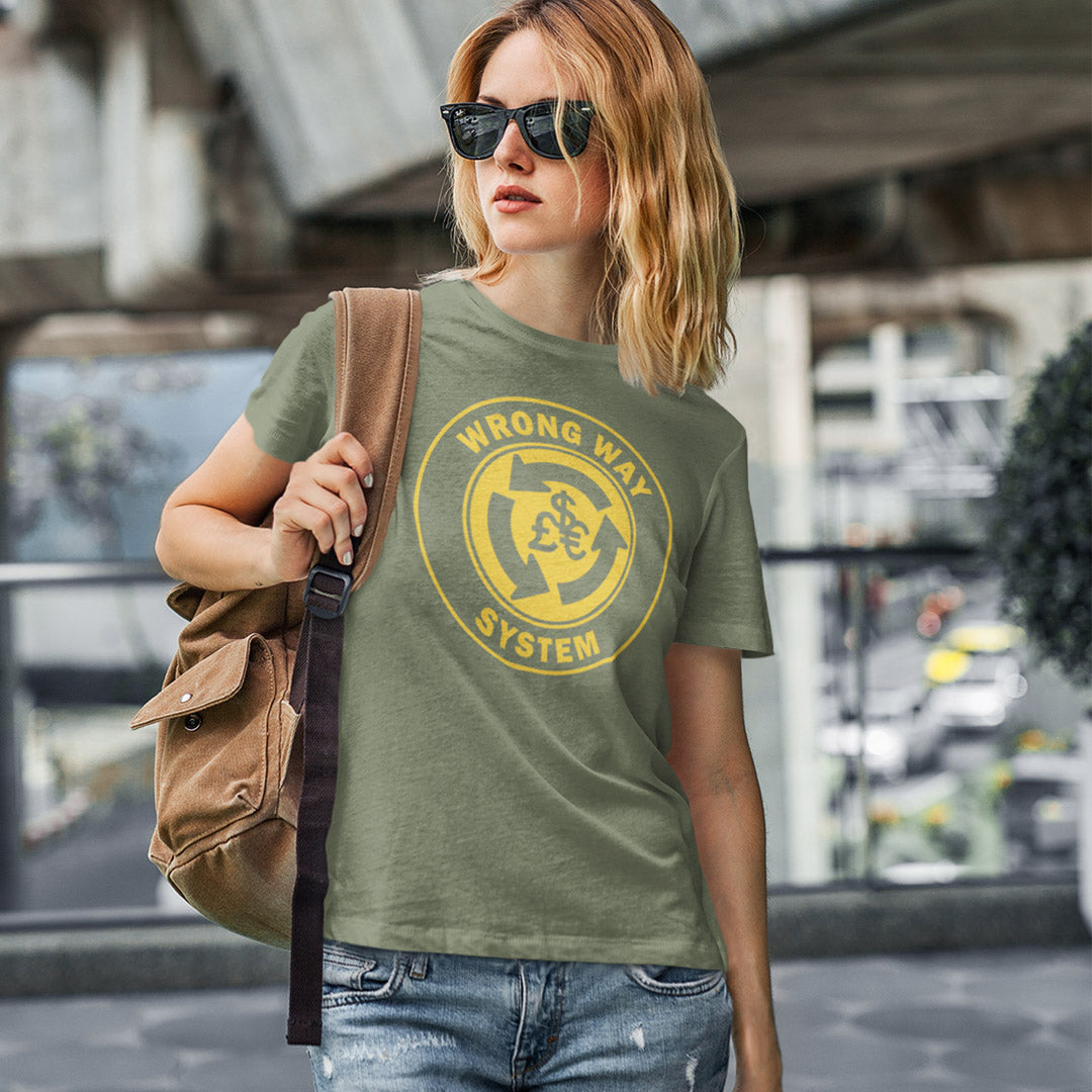 Person wearing a green t-shirt with a yellow graphic and text, holding a brown bag in an urban setting. A non conformist t shirt in the form of a road sign reminder that it's possibly not been the best idea to build our society around money. Wrong direction, change the system ! Made from 100% organic ring-spun cotton, this social awareness t shirt is unisex, high-quality, super comfy, and best of all, eco-friendly. A great choice for an anti capitalist socio economic demonstration.