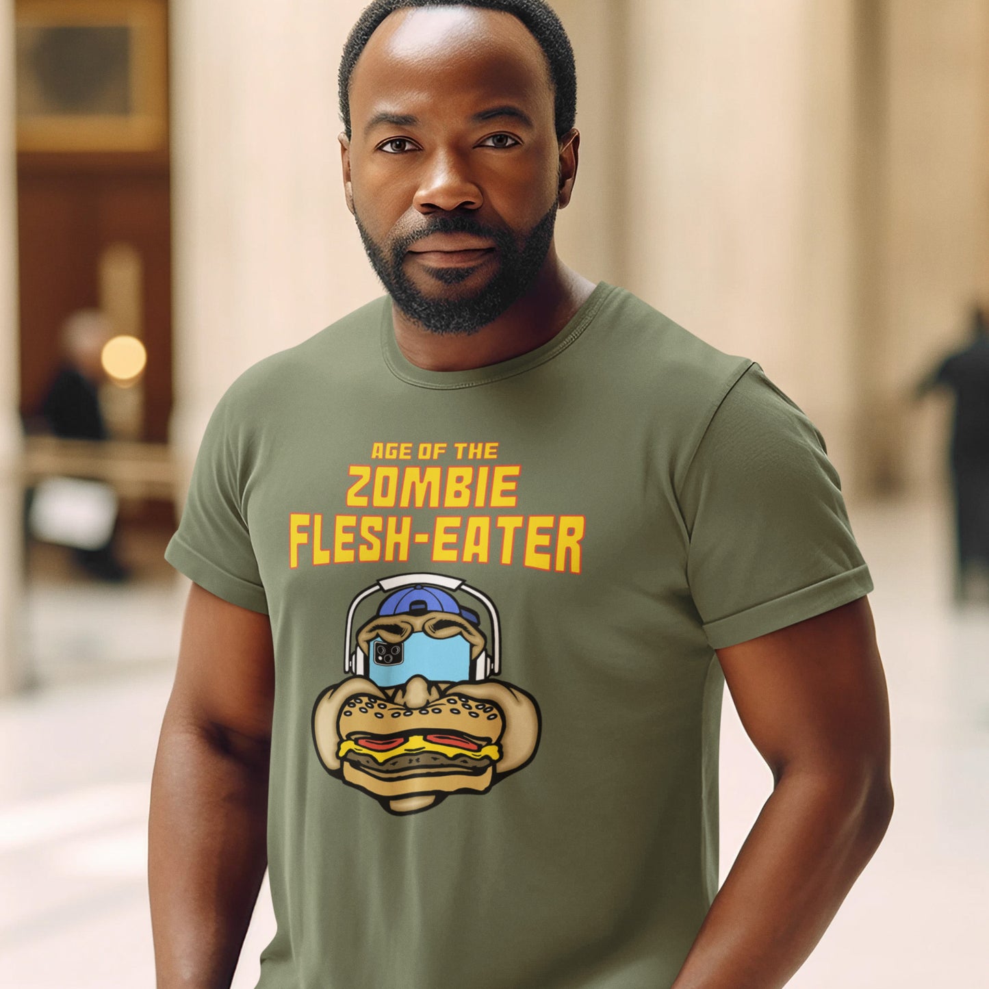 Man wearing a khaki t-shirt with a graphic design and text. This meat free t-shirt design plays on the interpretation of a late 70's B rate movie. As a modern day vegan surrounded by people hypnotised on their mobile phone while eating meat based fast food, you may be forgiven for thinking you are living in the age of the zombie flesh-eater. Made from 100% organic ring-spun cotton, this meat free t shirt design is unisex, high-quality, super comfy, and best of all, eco-friendly.