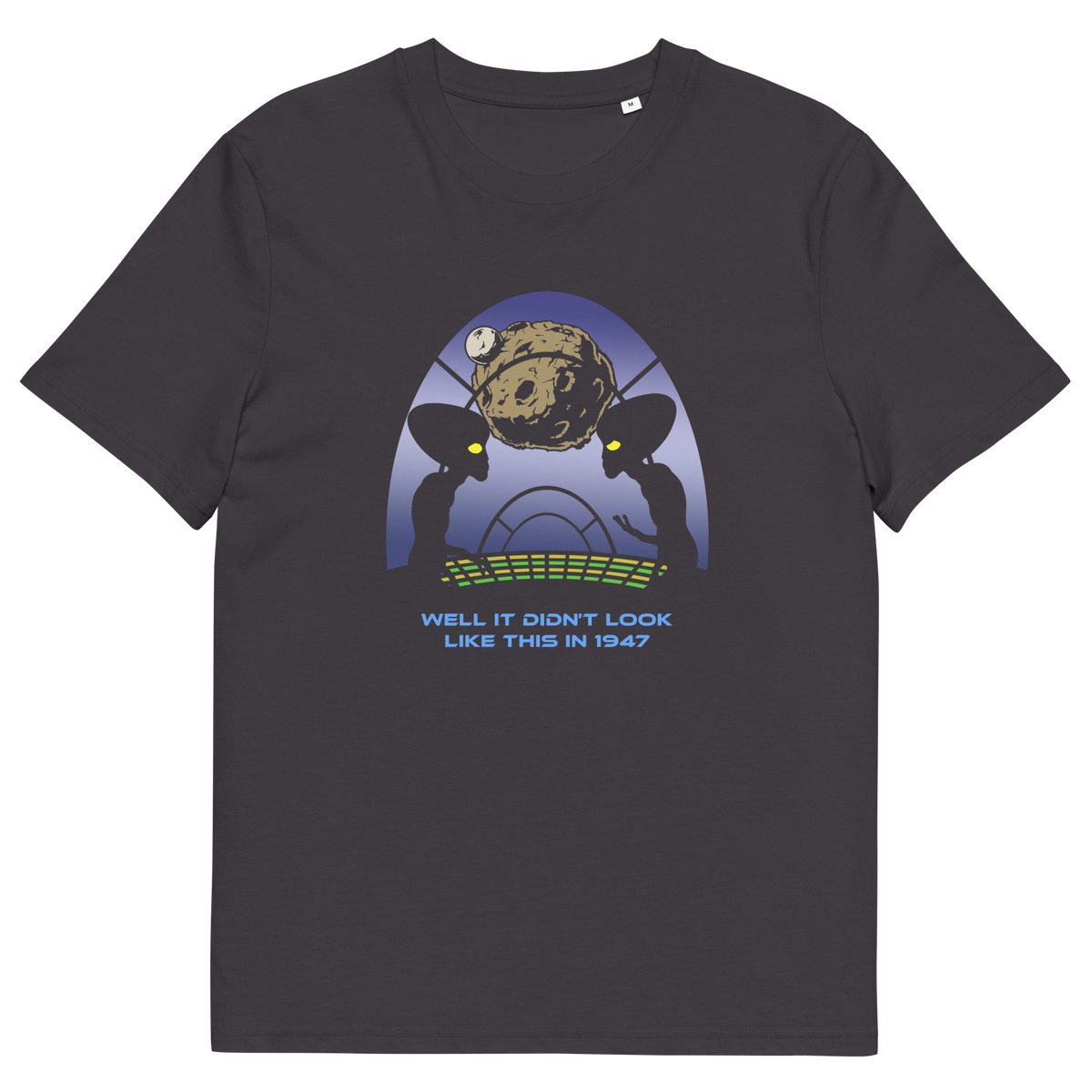 A dark charcoal gray crewneck t-shirt featuring a retro sci-fi graphic of two alien figures with large black eyes looking at a brown planet, with the text 'WELL IT DIDN'T LOOK LIKE THIS IN 1947' printed below.