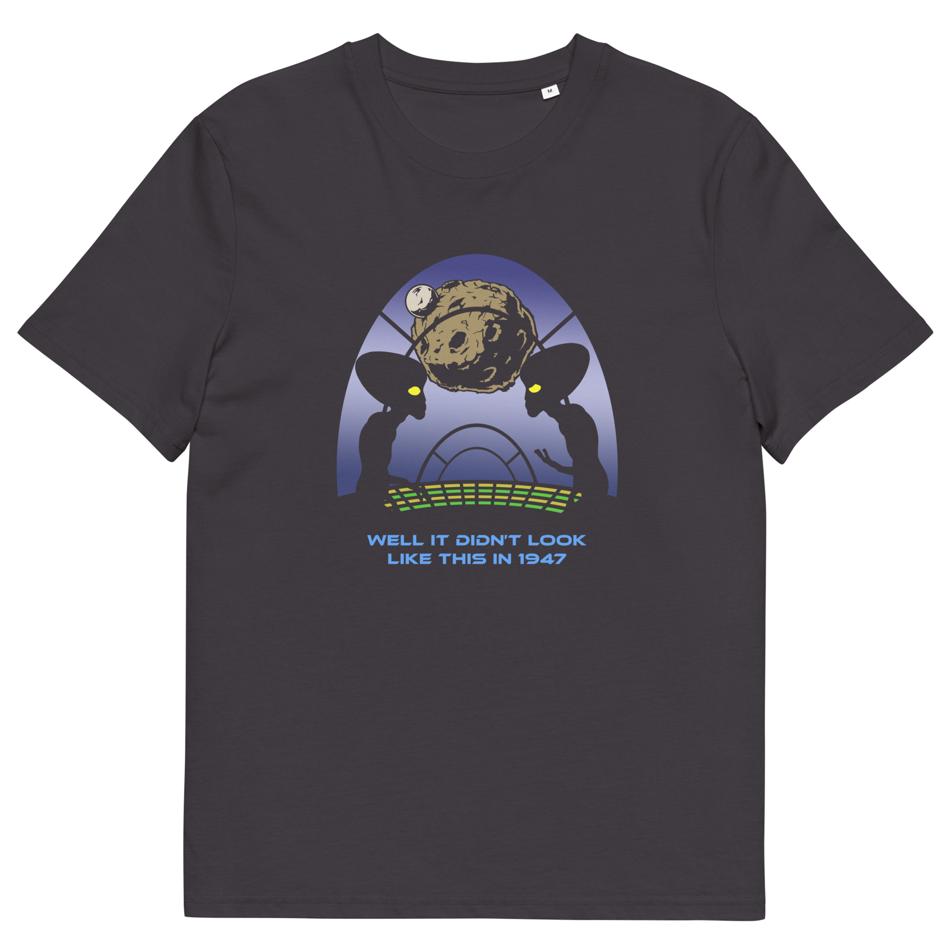 A dark charcoal gray crewneck t-shirt featuring a retro sci-fi graphic of two alien figures with large black eyes looking at a brown planet, with the text 'WELL IT DIDN'T LOOK LIKE THIS IN 1947' printed below.
