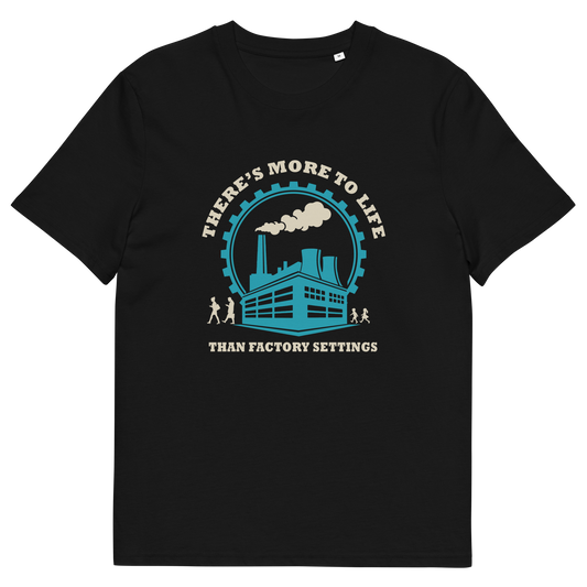A black short-sleeve crewneck t-shirt with a vintage-style graphic on the chest. The graphic features a teal and cream illustration of a factory building under a circular gear, with the text 'THERE'S MORE TO LIFE THAN FACTORY SETTINGS' in cream.