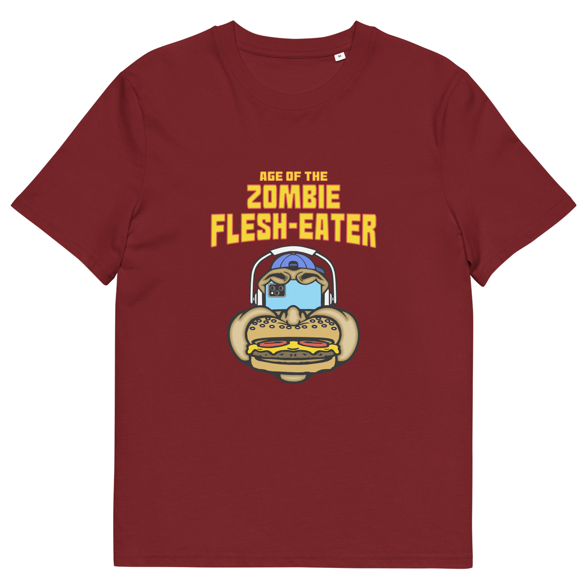 Burgundy t-shirt with a graphic on the front. The graphic features the text 'AGE OF THE ZOMBIE FLESH-EATER' in yellow, above a cartoon zombie head wearing headphones and biting a burger.