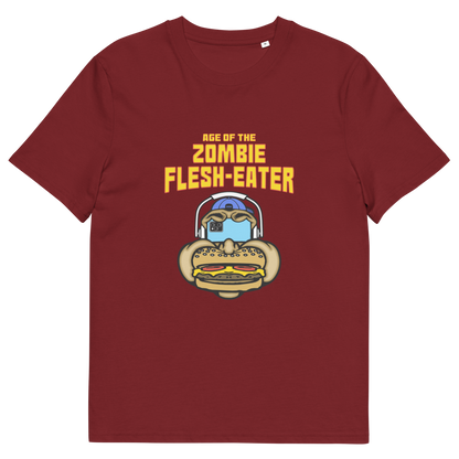Burgundy t-shirt with a graphic on the front. The graphic features the text 'AGE OF THE ZOMBIE FLESH-EATER' in yellow, above a cartoon zombie head wearing headphones and biting a burger.