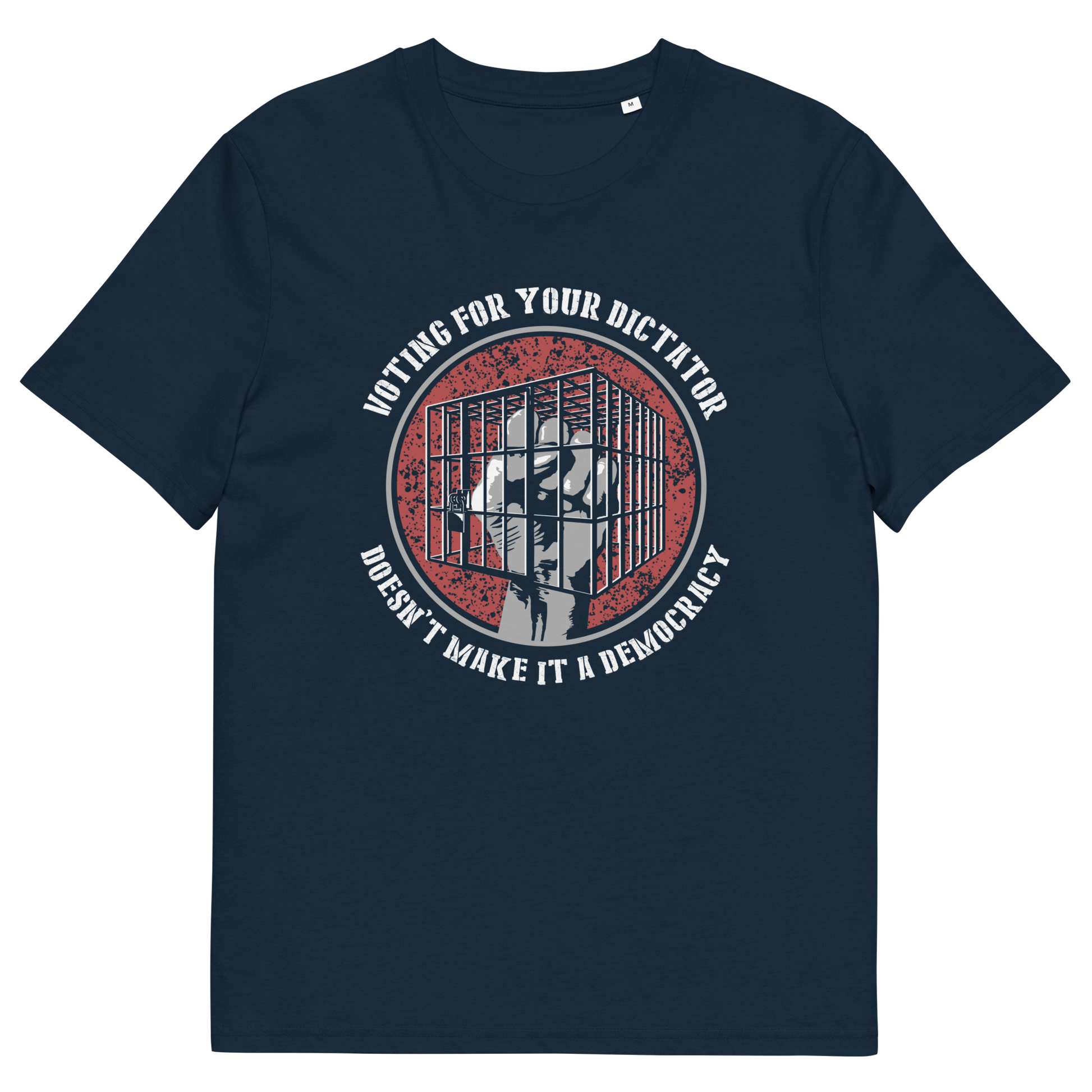 A French navy blue short-sleeve t-shirt with a circular graphic on the chest. The graphic features a distressed red background with a white silhouette of a person behind bars, surrounded by the text 'VOTING FOR YOUR DICTATOR' on top and 'DOESN'T MAKE IT A DEMOCRACY' below.