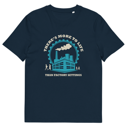 A French navy blue short-sleeve crewneck t-shirt with a graphic print on the front. The graphic features a light blue and cream illustration of an industrial factory building under a circular gear and the text 'THERE'S MORE TO LIFE THAN FACTORY SETTINGS'.