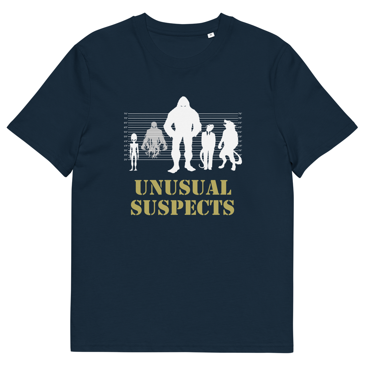A French navy blue short-sleeve crewneck t-shirt with a graphic on the chest showing white silhouettes of various creatures against a height line up chart, with the text 'UNUSUAL SUSPECTS' printed below in a muted gold color.