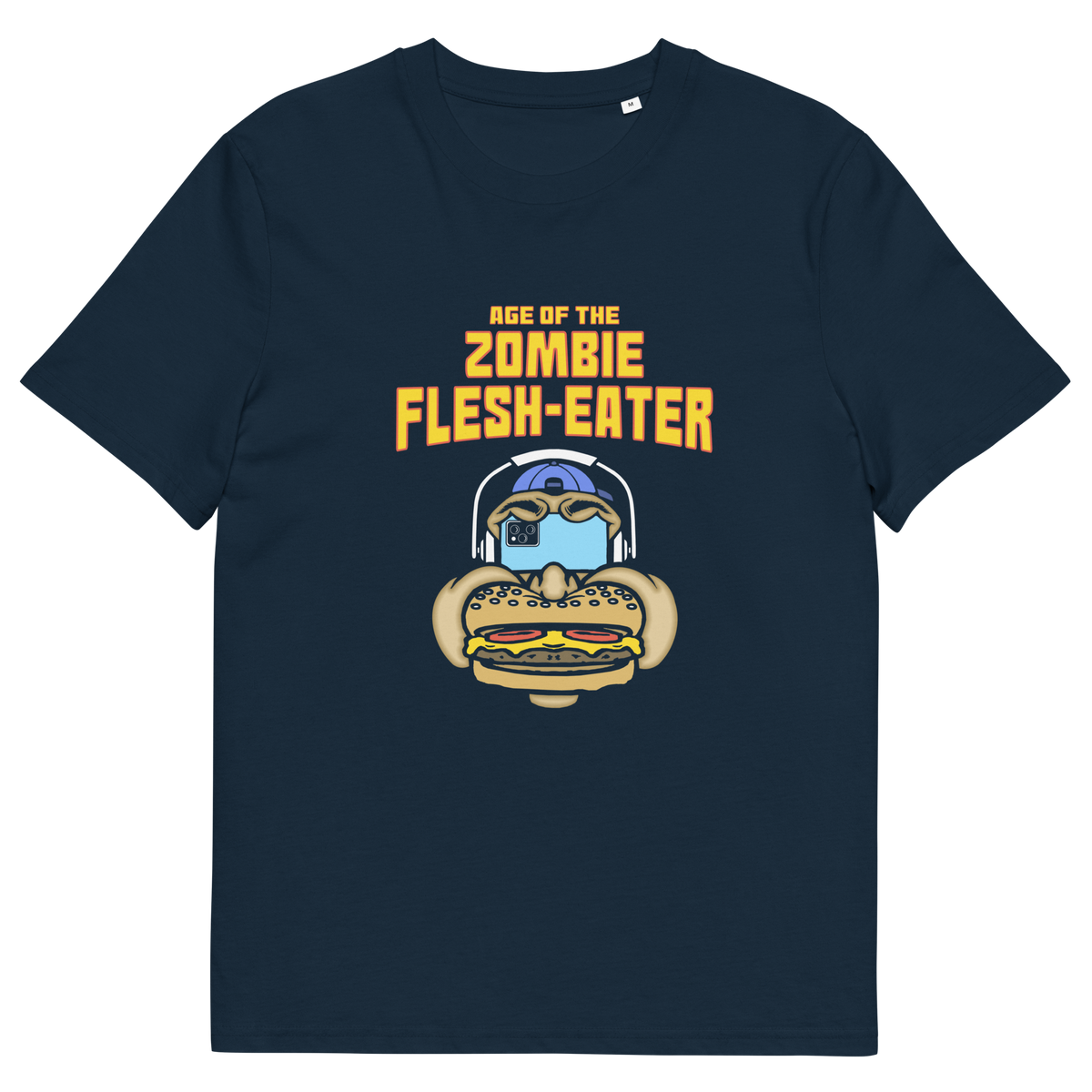 A French navy blue short-sleeve t-shirt with a graphic on the front. The graphic features the text 'AGE OF THE ZOMBIE FLESH-EATER' in yellow, above a cartoon zombie head wearing headphones and biting a burger.