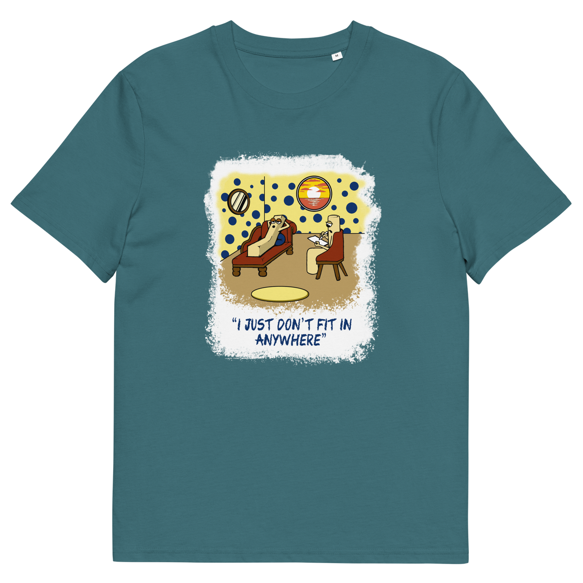 A stargazer blue short-sleeve t-shirt with a central graphic print. The graphic features a cartoon illustration of a person sitting on a lounge chair in a theorists room , with a white distressed border and the text 'I JUST DON'T FIT IN ANYWHERE' below.