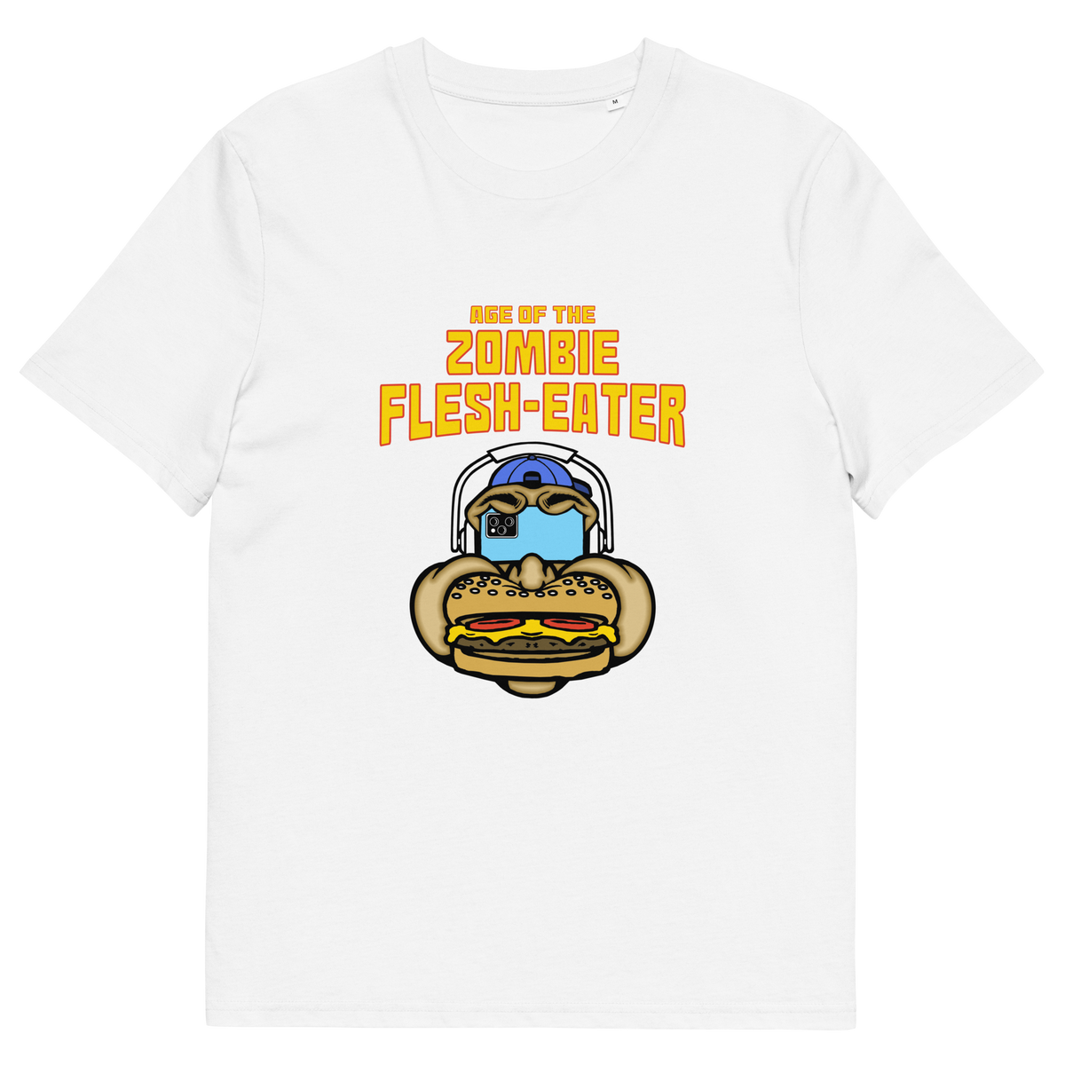 White t-shirt with a graphic on the front. The graphic features the text 'AGE OF THE ZOMBIE FLESH-EATER' in yellow, above a cartoon zombie head wearing headphones and biting a burger.