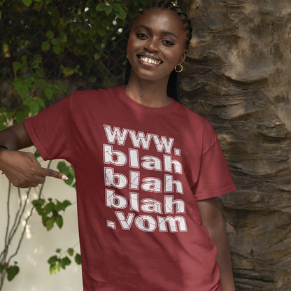 A woman standing outside, pointing at her burgundy t-shirt with "www.blahblahblah.vom" text design.