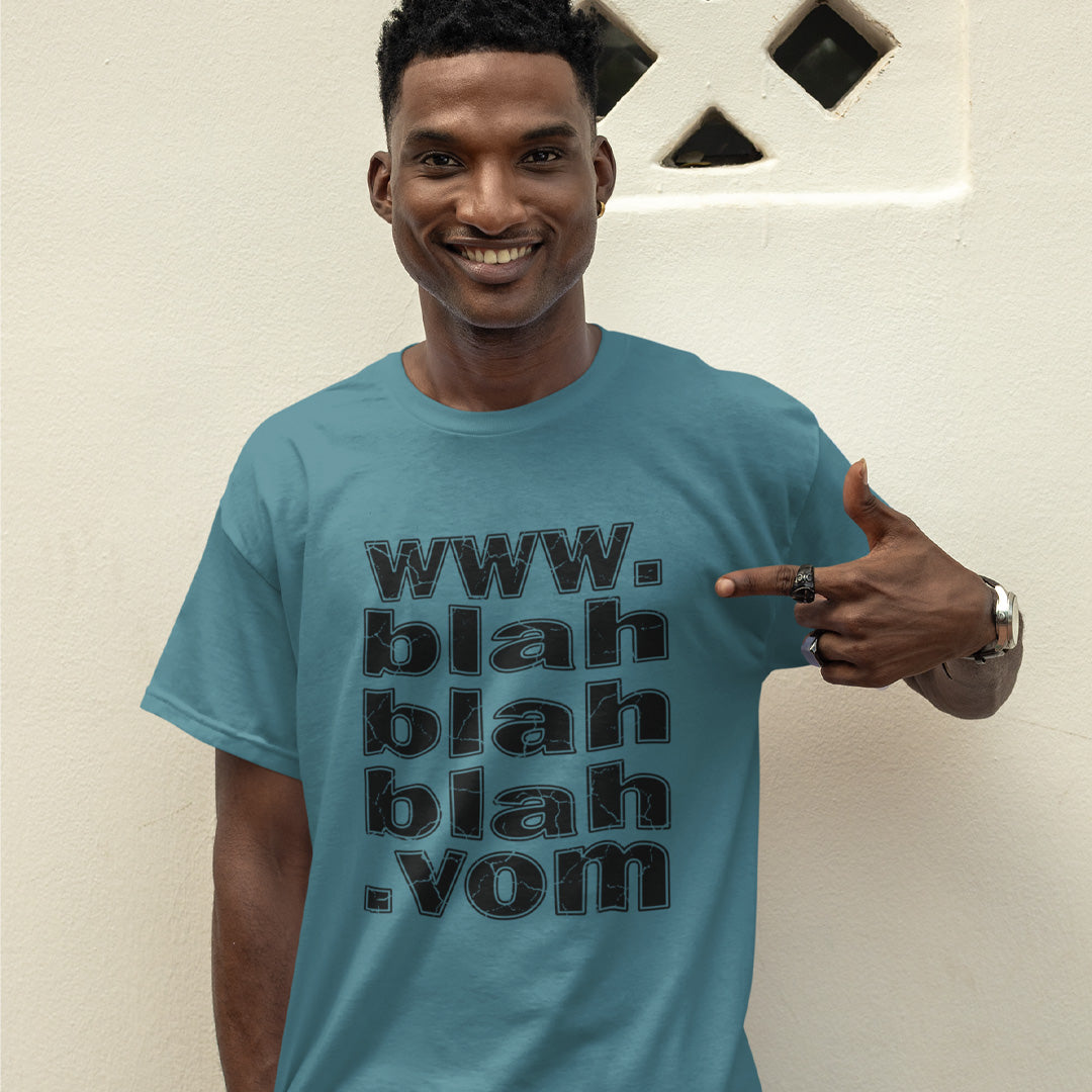 A smiling man standing outdoors, wearing a stargazer blue t-shirt with "www.blahblahblah.vom" text design.